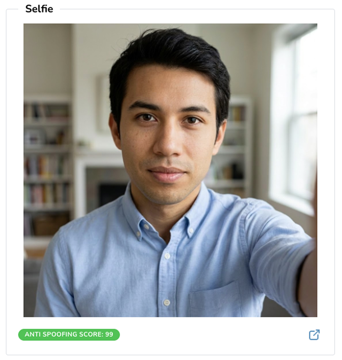 Selfie with Anti Spoofing Score Person taking a selfie in a well-lit room with bookshelves and a window in the background.